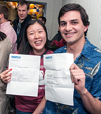 Two students with their match letters