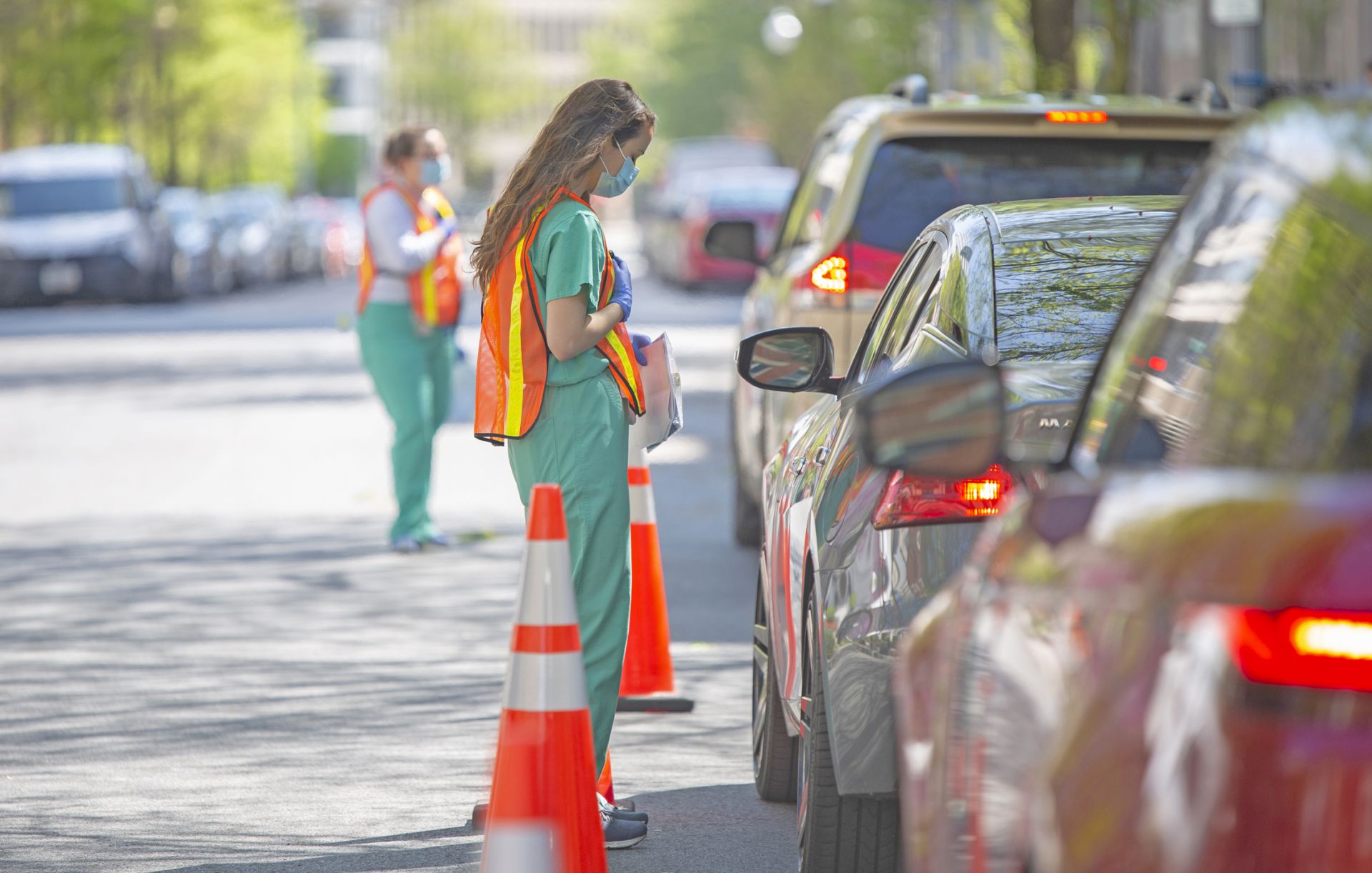 Volunteers helped administer drive-up COVID-19 testing on campus. Volunteer helps with a drive-up COVID-19 testing clinic