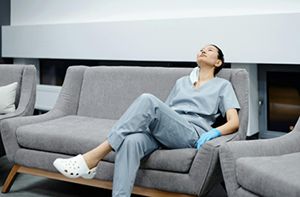 Female medical professional relaxing on a couch
