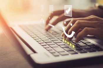 Hands at a keyboard for online education.